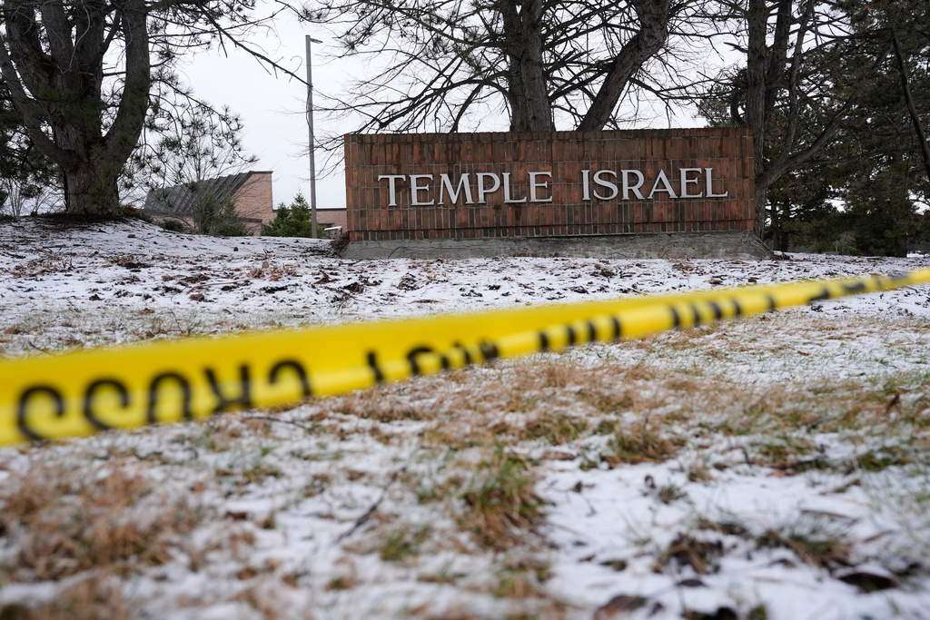 Police tape hangs outside the Temple Israel synagogue Friday, March 13, 2026, in West Bloomfield Township, Mich. 