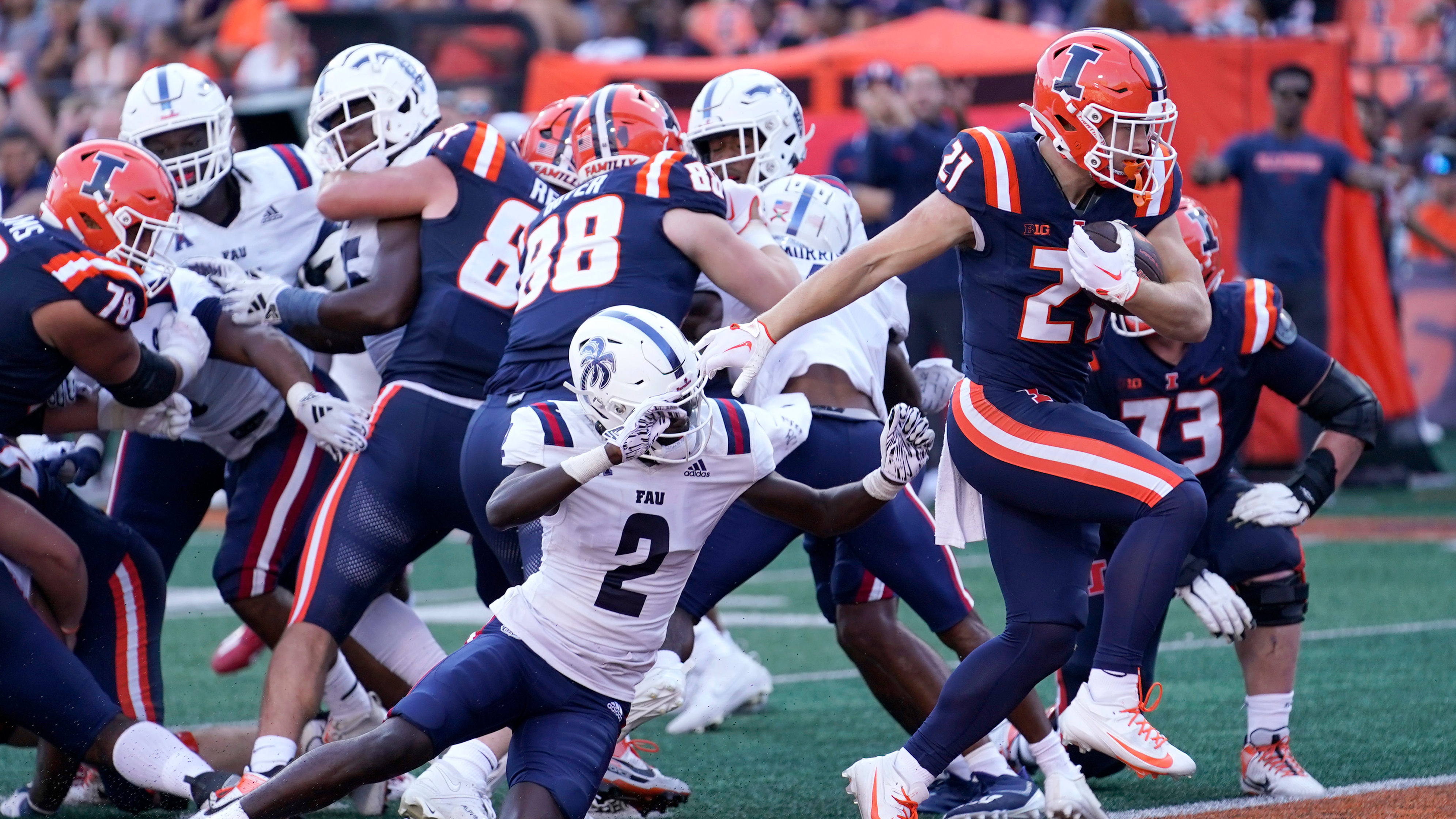 Illinois running back Aidan Laughery, front right, scores past Florida Atlantic cornerback Romain Mungin (2) during the second half of an NCAA college football game Saturday, Sept. 23, 2023, in Champaign, Ill. 