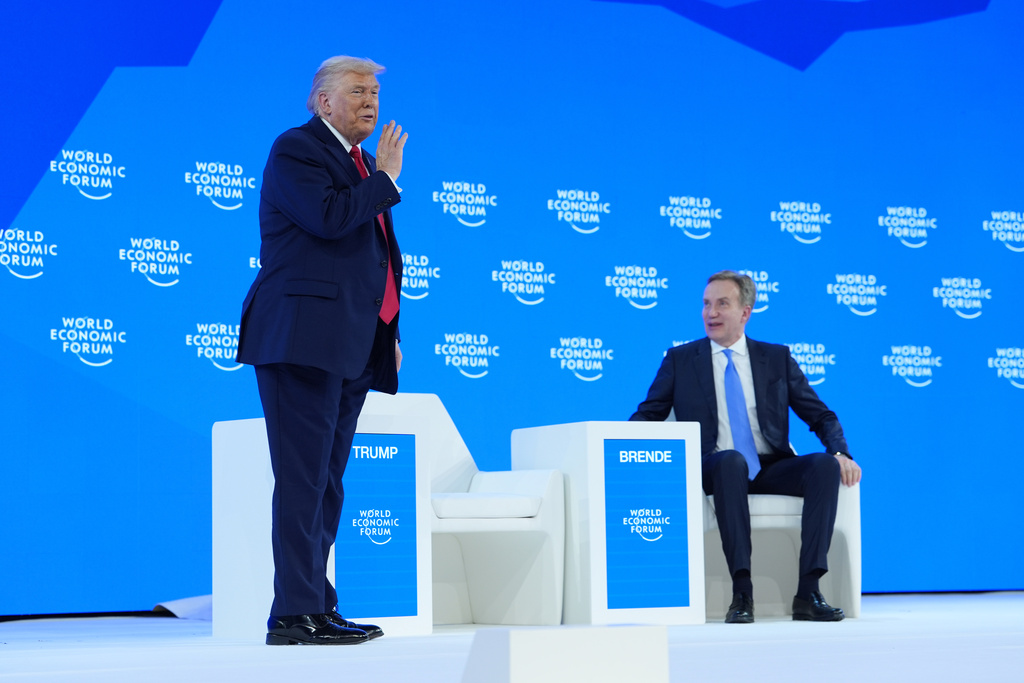 President Donald Trump, left, prepares to speak on a panel with World Economic Forum President Borge Brende after addressing the audience during the Annual Meeting of the World Economic Forum in Davos, Switzerland, Wednesday, Jan. 21, 2026. 