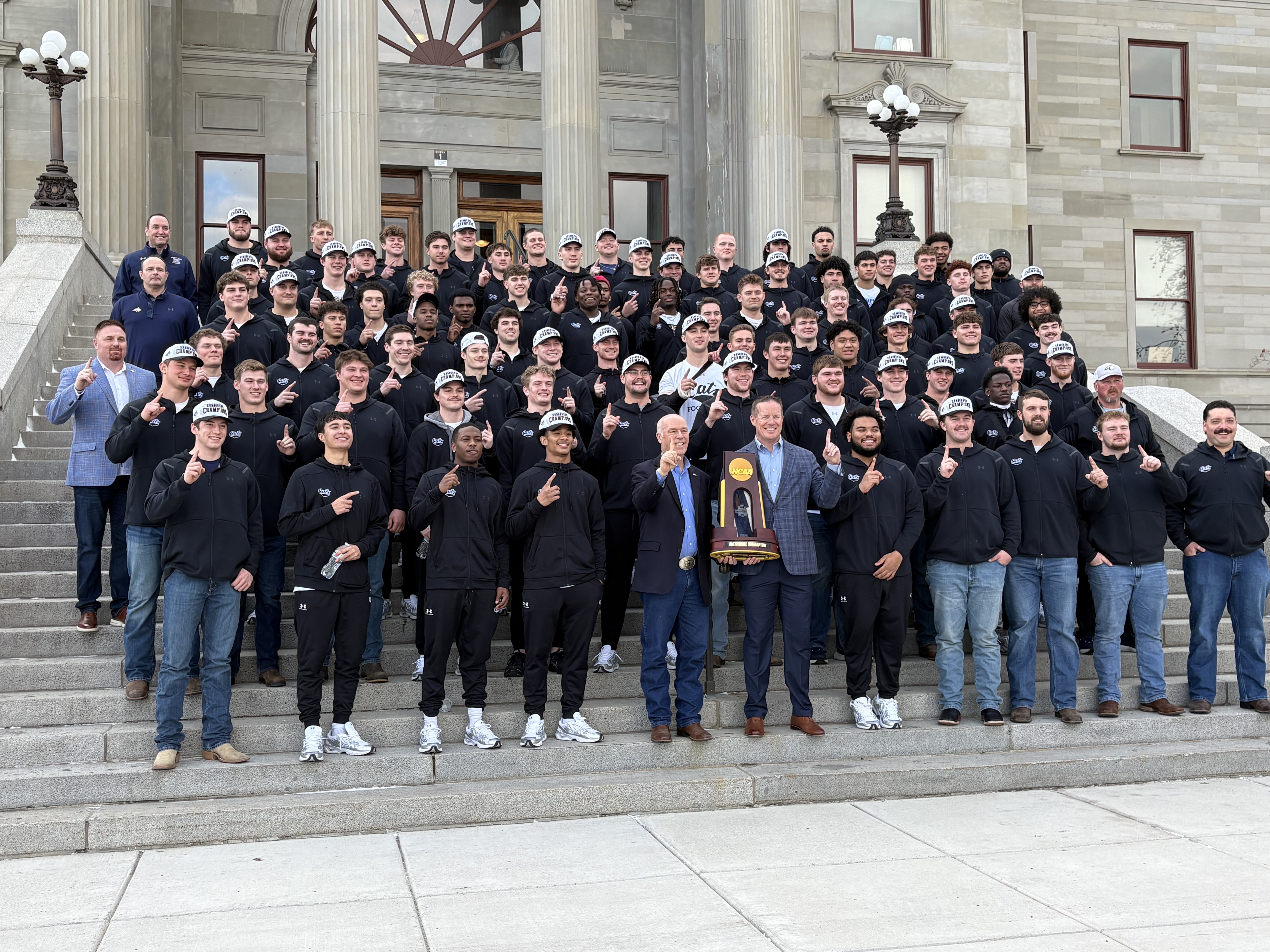 Montana State football team poses with Gov. Greg Gianforte at the State Capitol