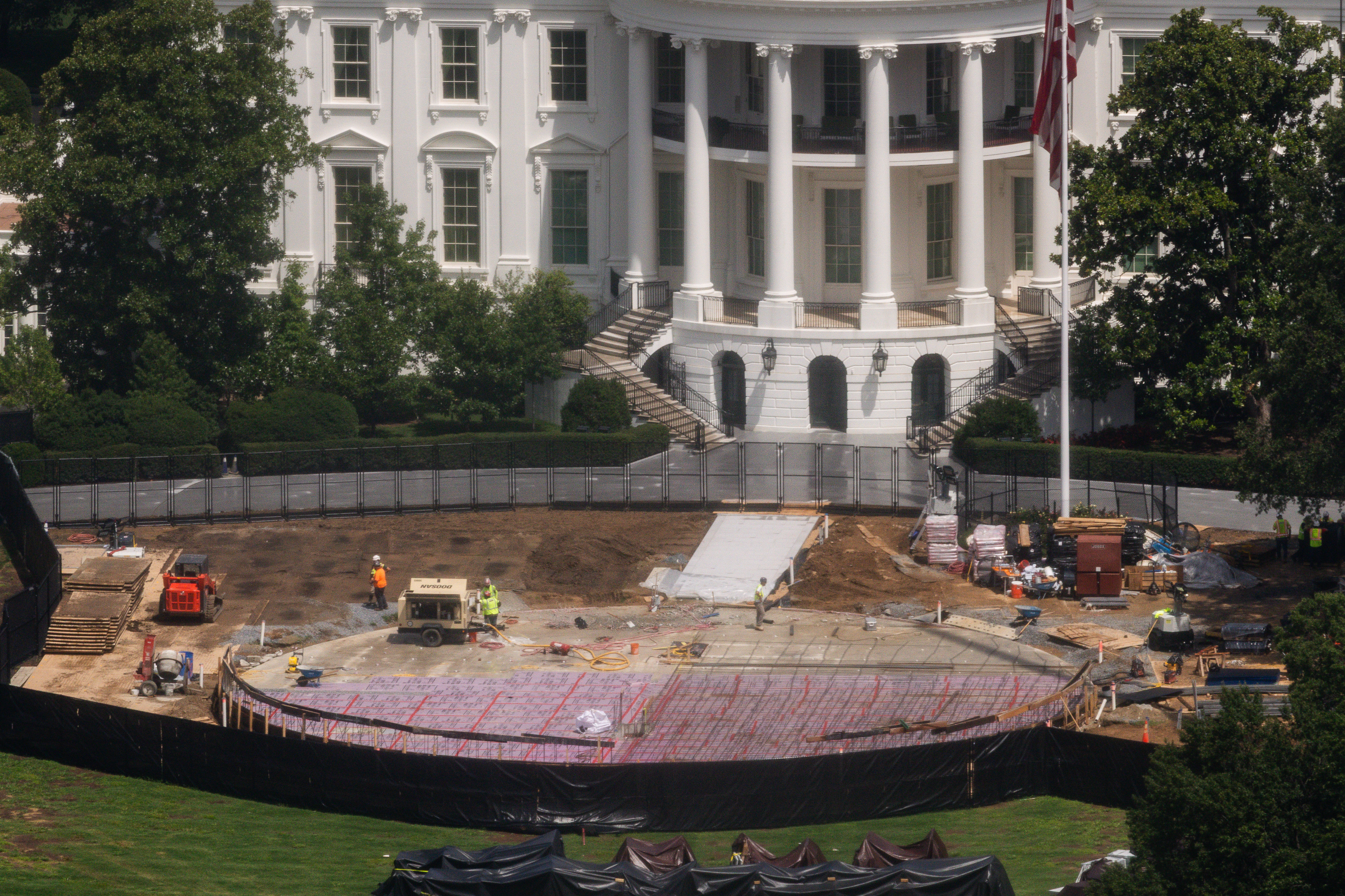 Construction continues on a helipad on the South Lawn of the White House, Wednesday, Aug. 5, 2026, in Washington.