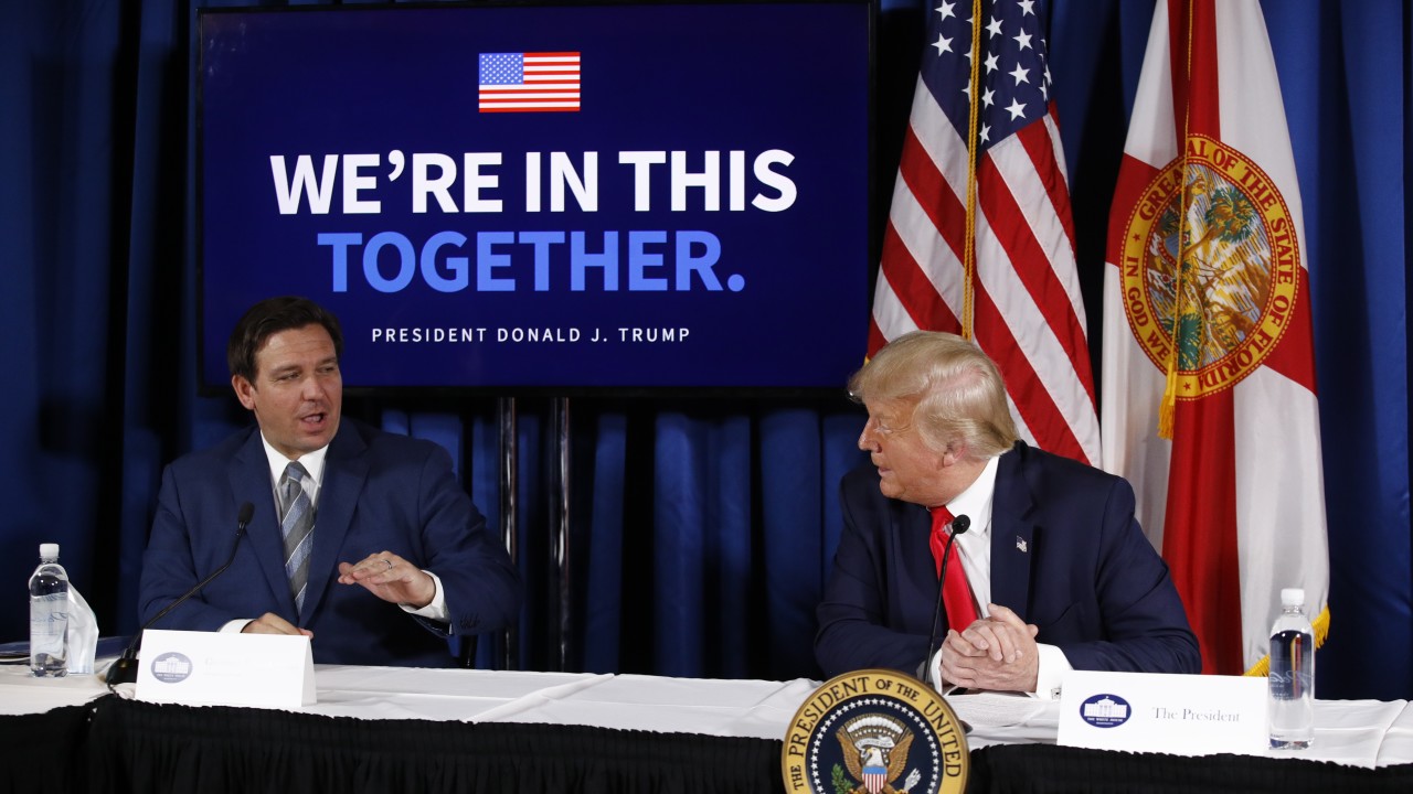 President Donald Trump speaks with Florida Gov. Ron DeSantis during a roundtable discussion on the coronavirus outbreak and storm preparedness, July 31, 2020, at Pelican Golf Club in Belleair, Fla.