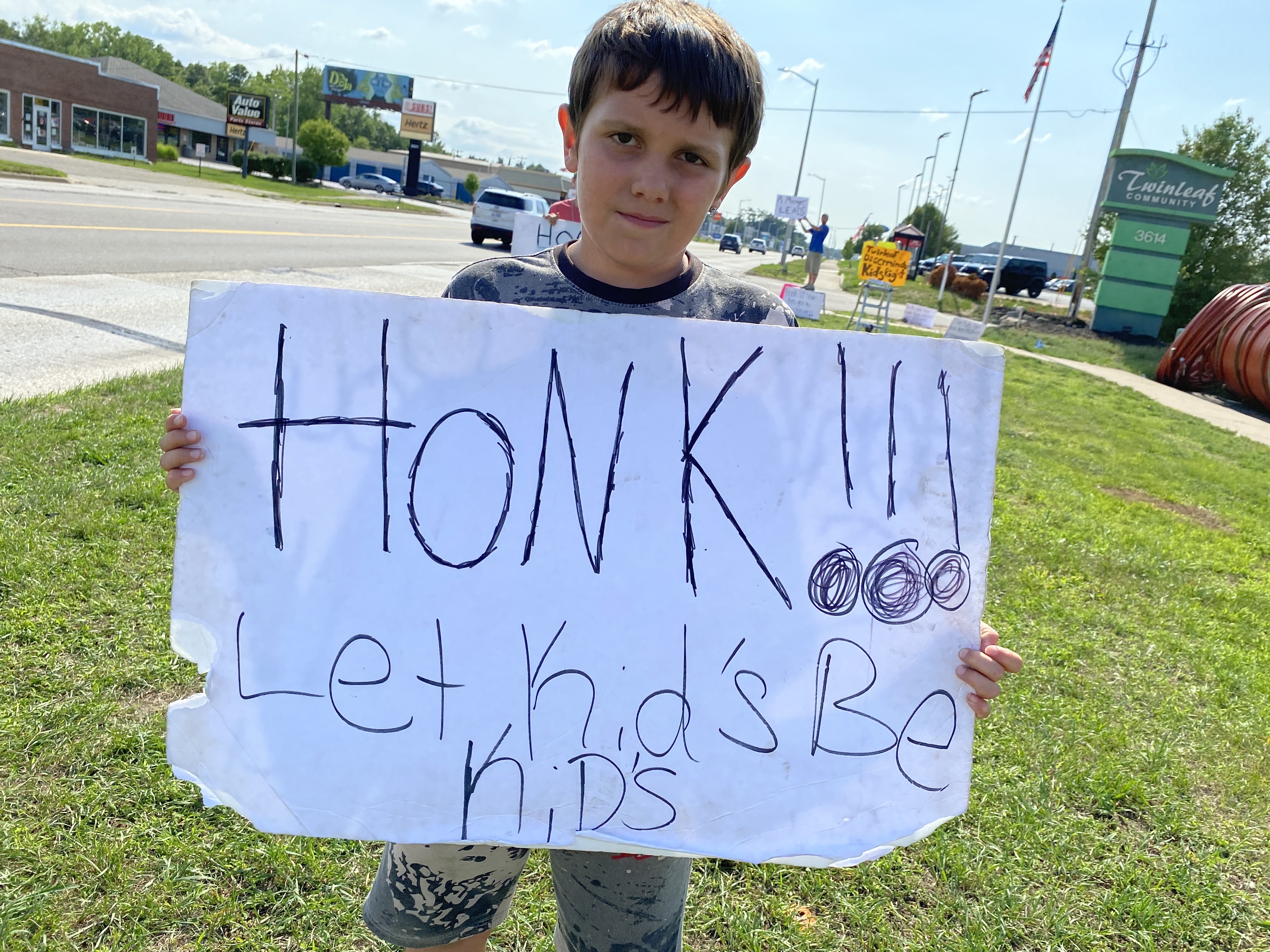Twinleaf policy on kids plays - kid holds sign.jpg