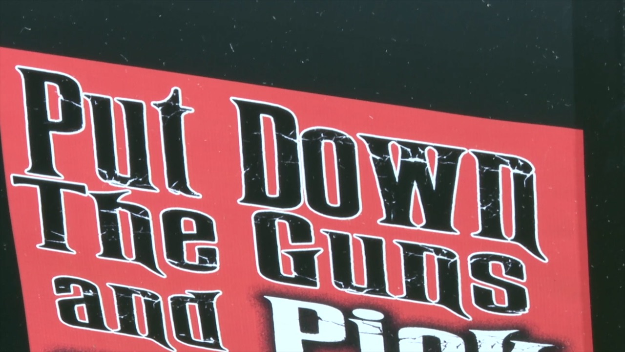 Put Down The Guns sign by Mikey 23 Foundation in Lansing
