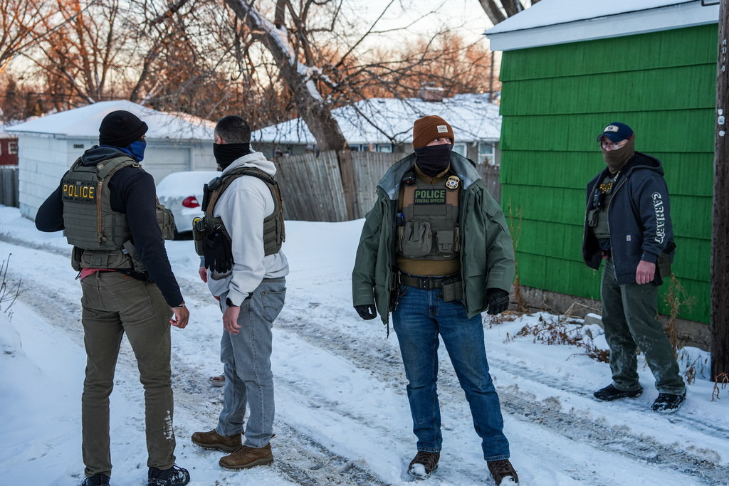 Federal agents conduct immigration enforcement operations in a neighborhood on Monday, Feb. 2, 2026, in Minneapolis. 