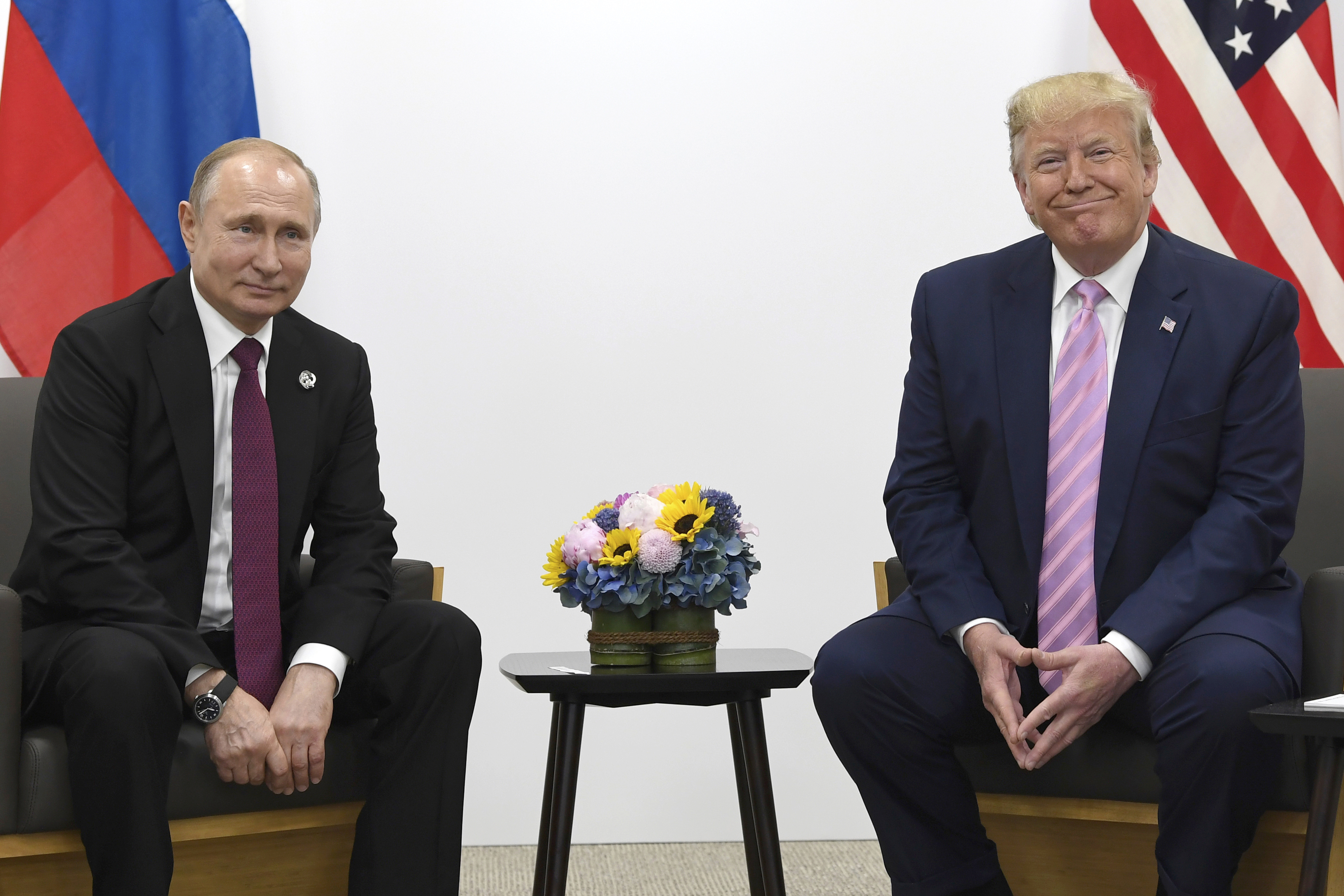 FILE - President Donald Trump, right, meets with Russian President Vladimir Putin on the sidelines of the G-20 summit in Osaka, Japan, June 28, 2019. 
