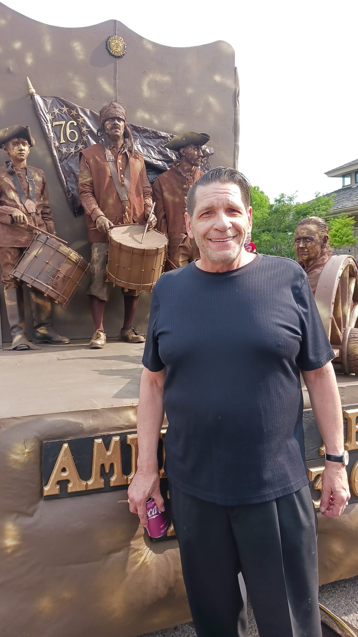 John Capriotti stands in front of Boys of 76 float