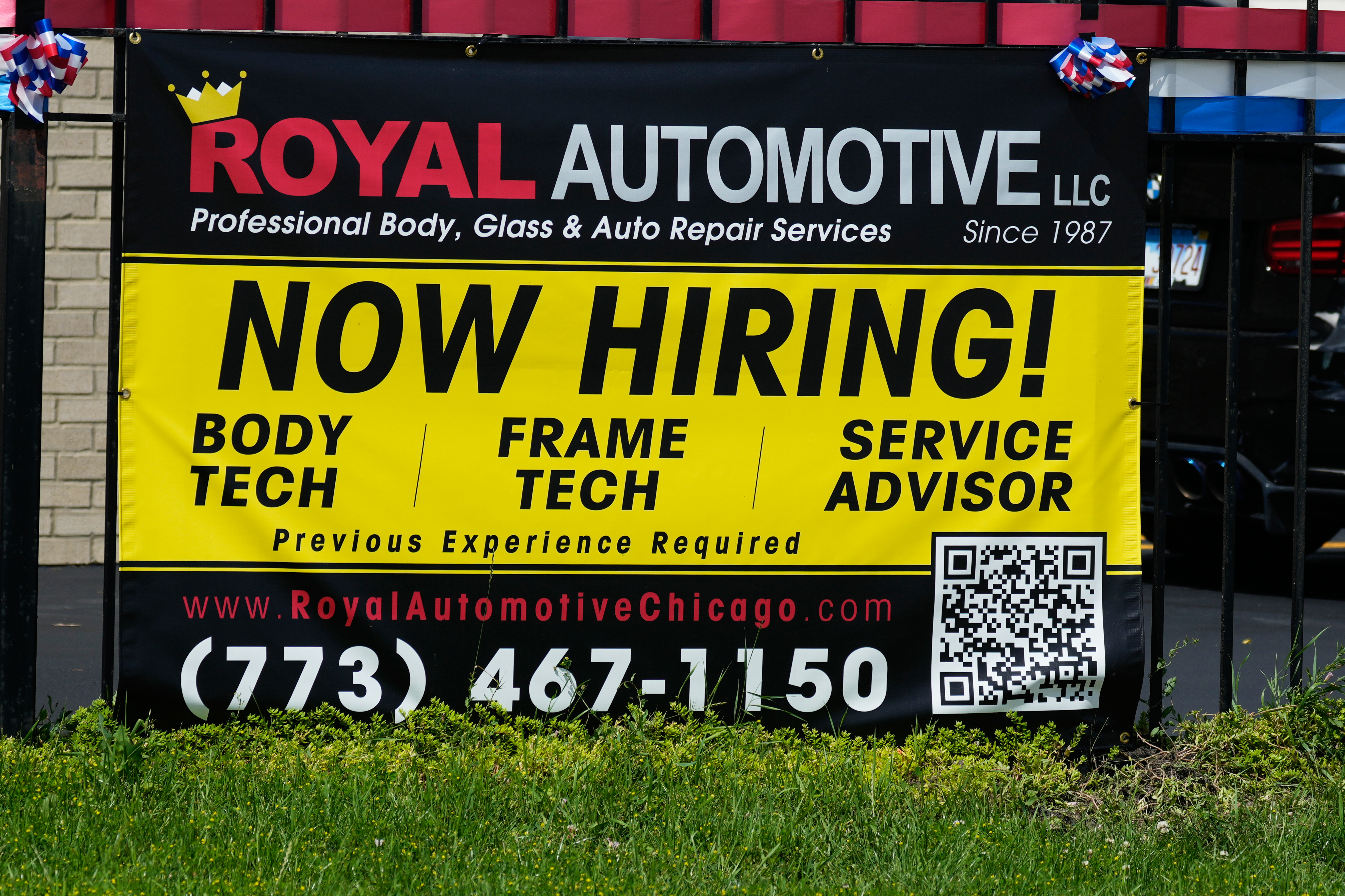 Now hiring sign is seen in front of an auto body shop in Chicago, Thursday, June 25, 2026. 
