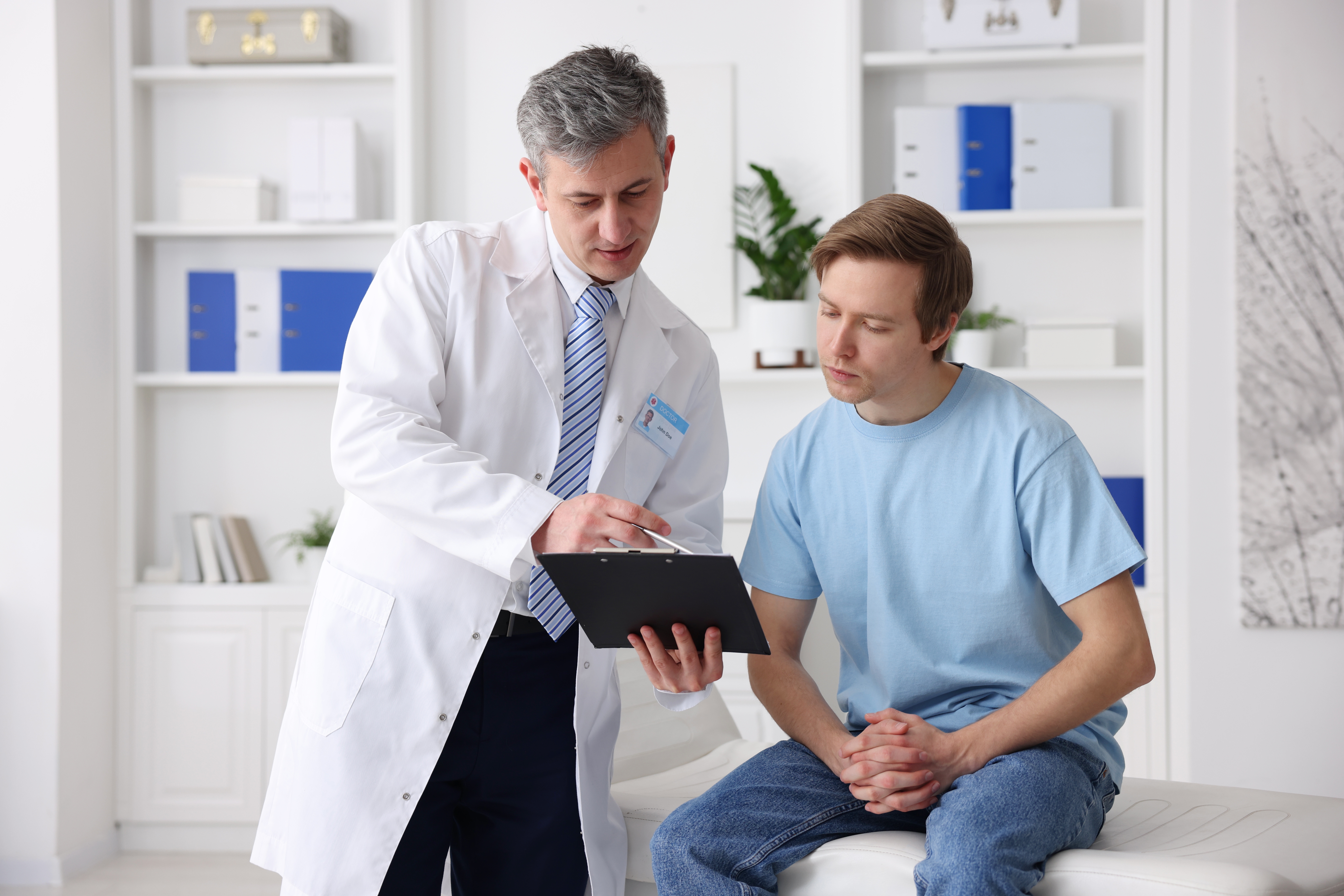 Man at the doctor receiving medical advice.