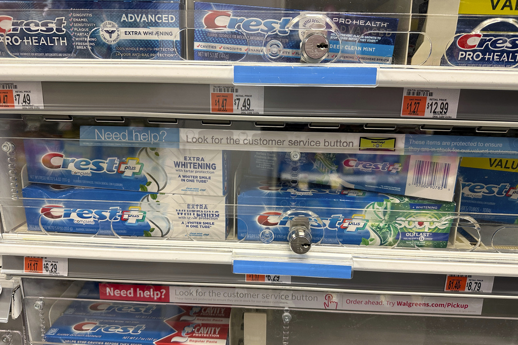 Tubes of toothpaste are displayed behind a locked, plastic barrier to prevent shoplifters from stealing the products at a store in the Manhattan borough of New York on January 31, 2024. 