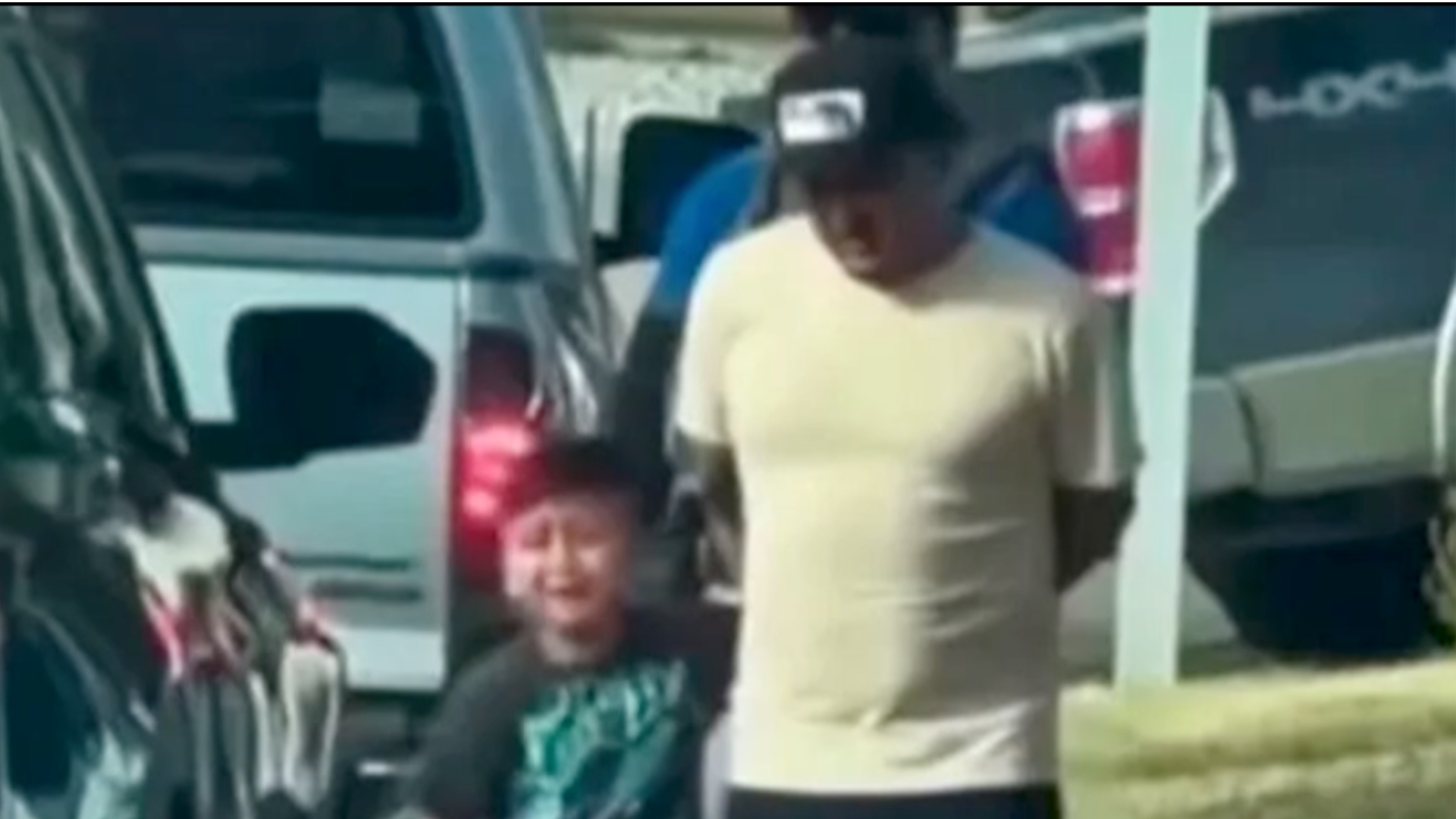 Liam Tadeo cries as his father is detained by immigration enforcement.