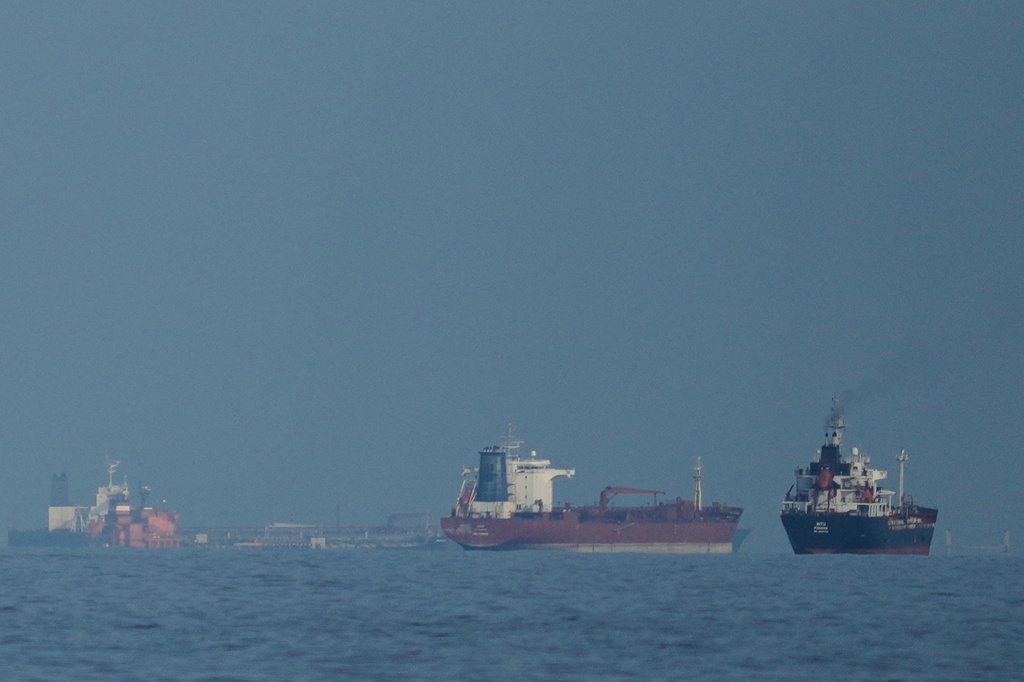 Oil tankers and cargo ships line up in the Strait of Hormuz as seen from Khor Fakkan, United Arab Emirates, Wednesday, March 11, 2026. 