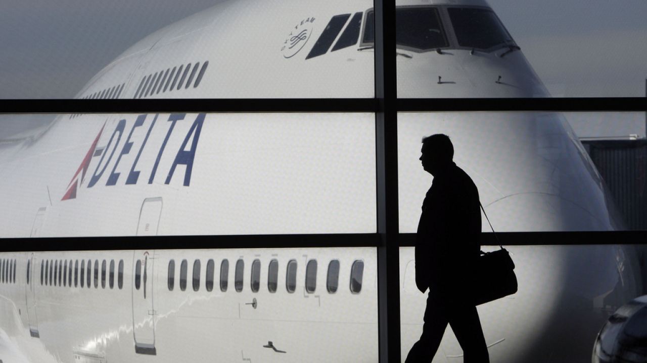 A passenger walks past a plane.