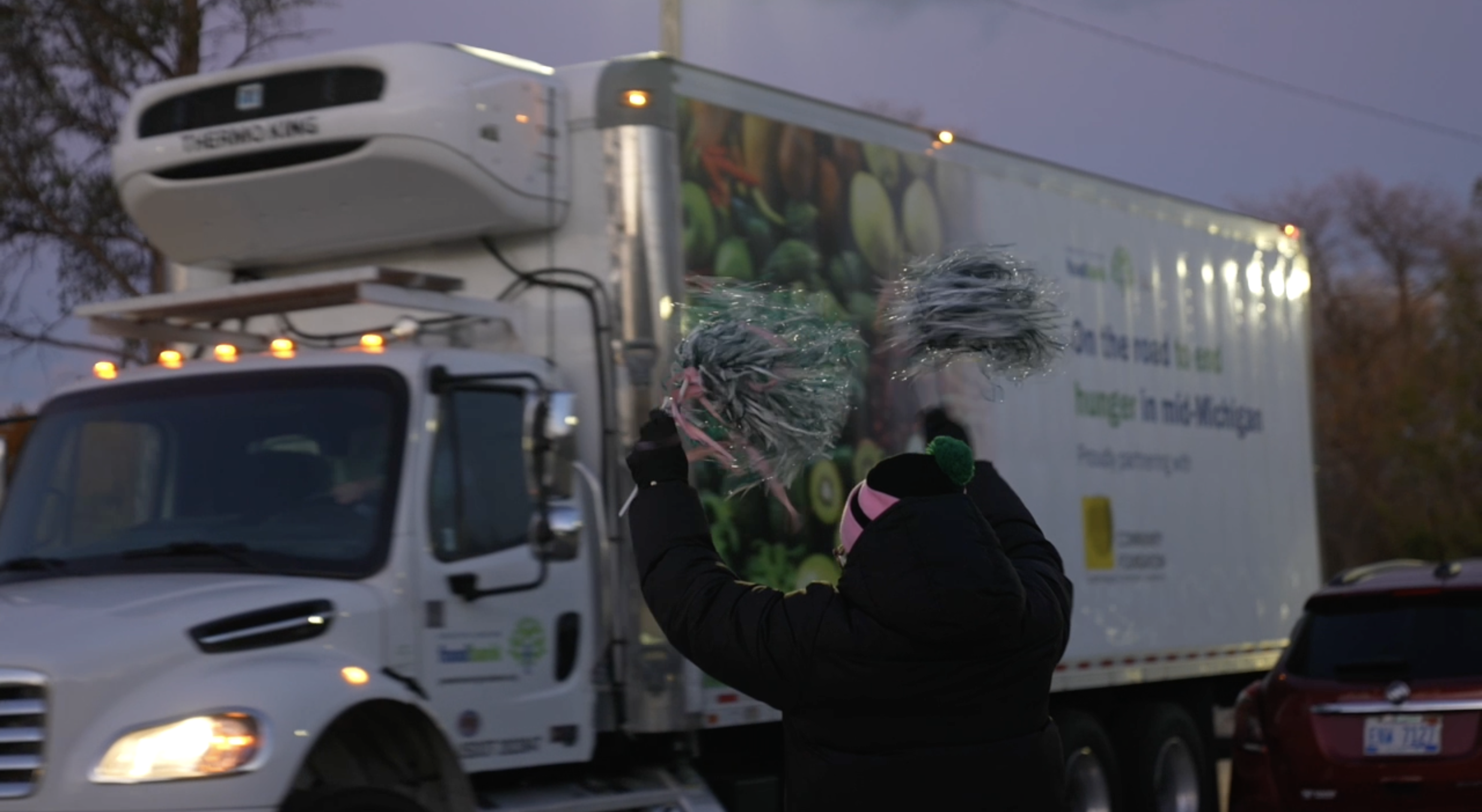 Greater Lansing Food Bank truck and volunteer 