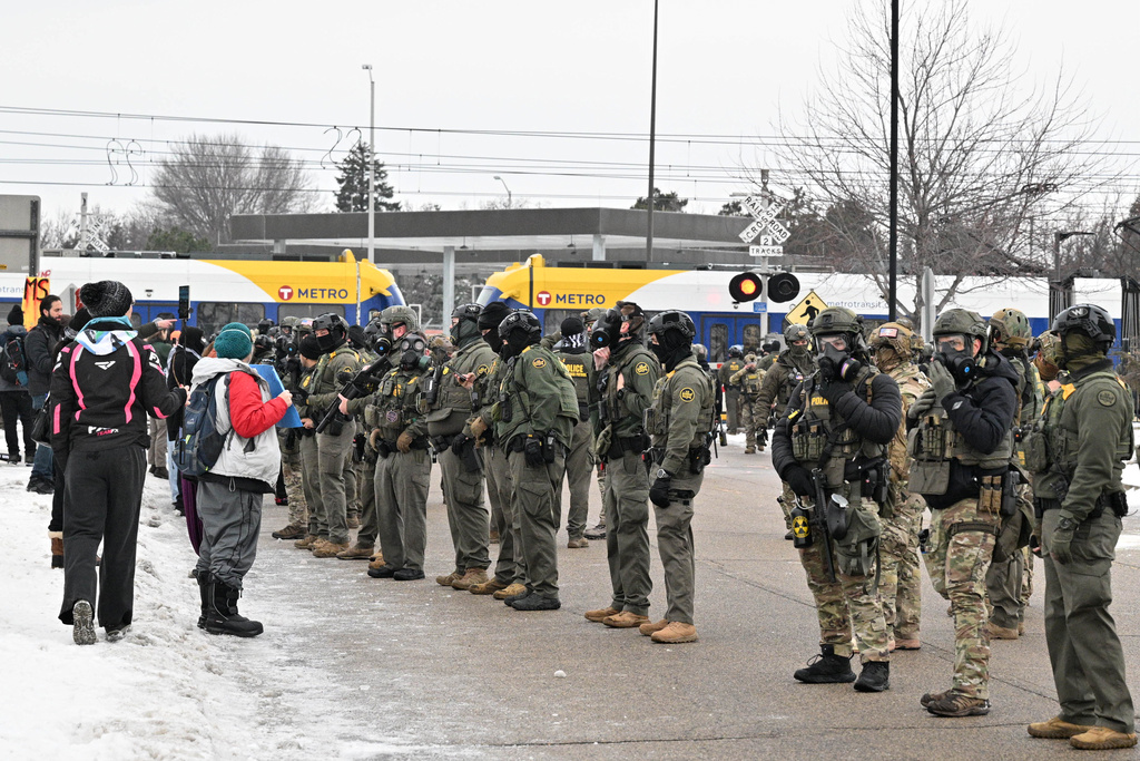 Protesters confront federal agents outside the Bishop Henry Whipple Federal Building, Thursday, Jan. 8, 2026, in Minneapolis, Minn.