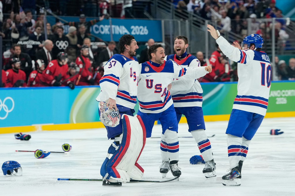 United States players celebrate after defeating Canada during a men's ice hockey gold medal game between Canada and the United States at the 2026 Winter Olympics, in Milan, Italy, Sunday, Feb. 22, 2026.