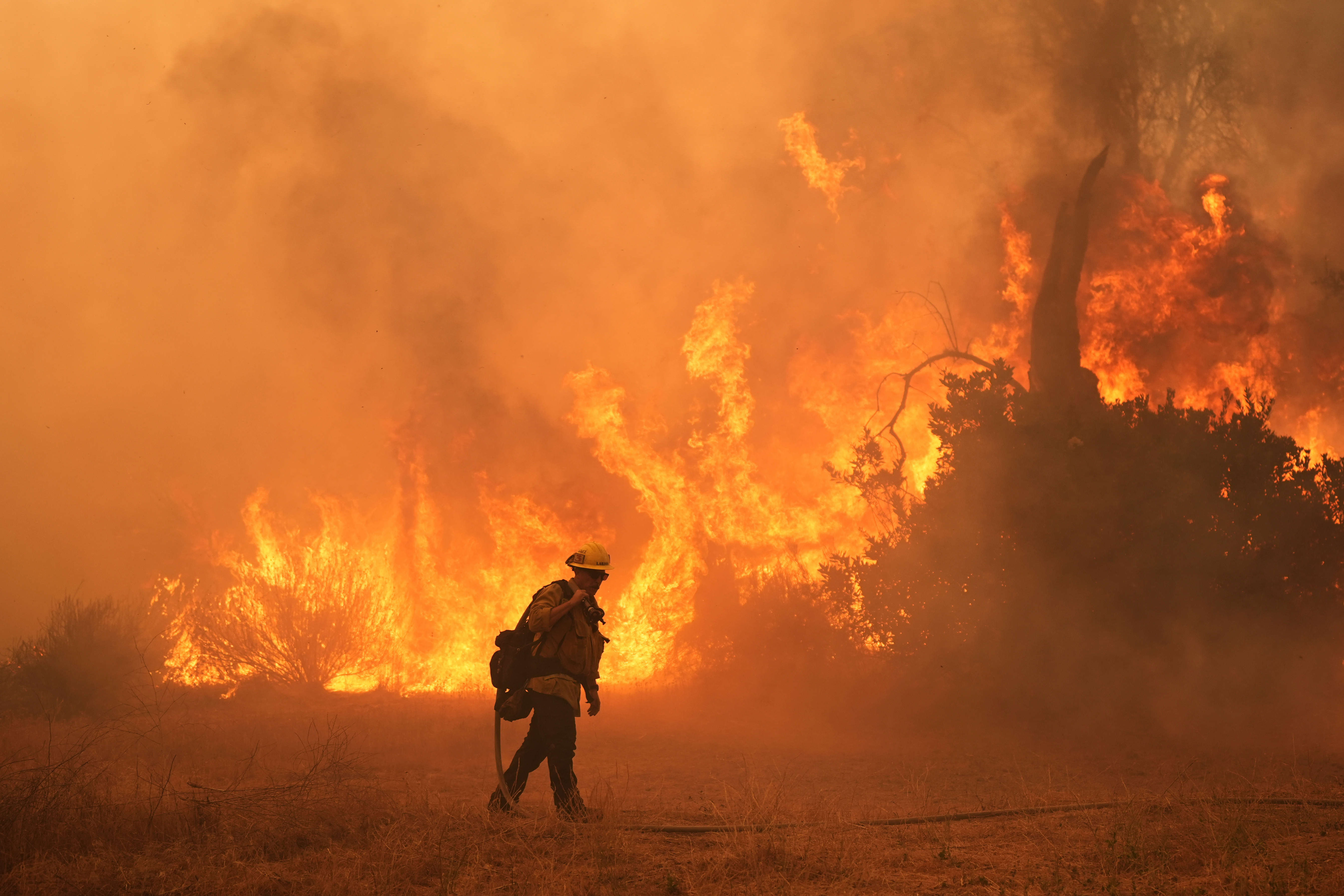 FILE - A firefighter battles the Canyon Fire on Aug. 7, 2025, in Hasley Canyon, Calif.