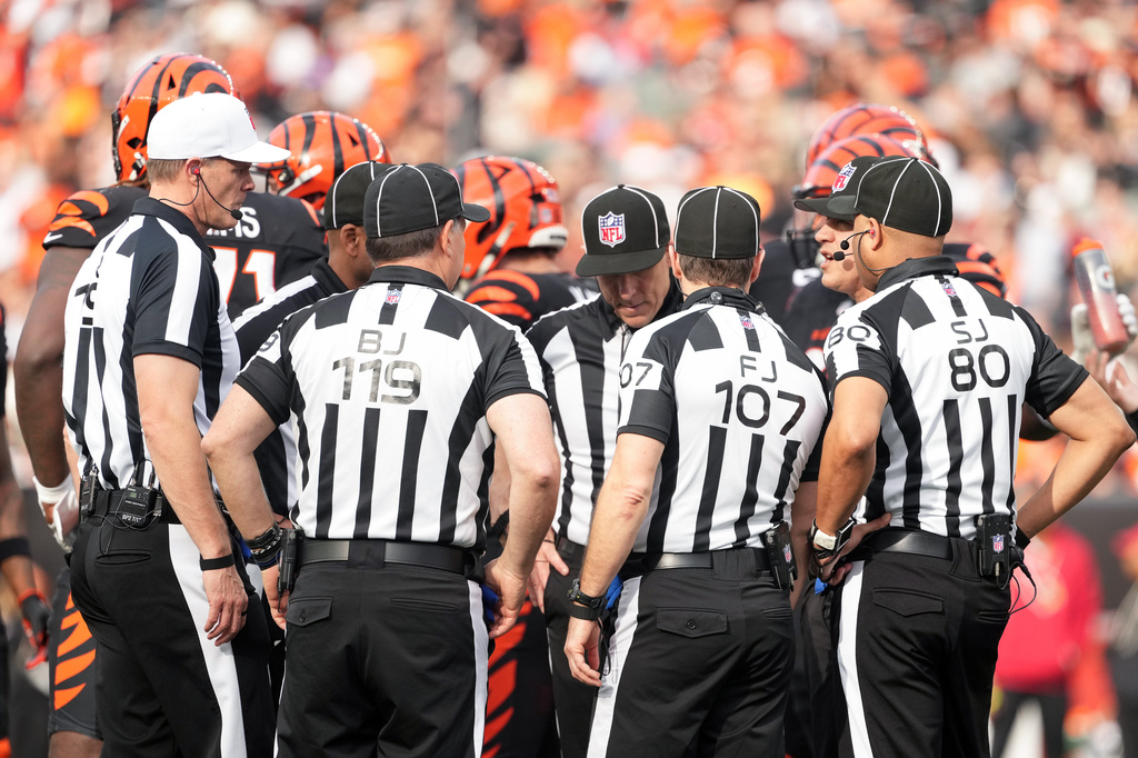 Referee Clay Martin (19), far left, talks with the officiating crew during an NFL football game between the Arizona Cardinals and the Cincinnati Bengals, Sunday, Dec. 28, 2025, in Cincinnati.