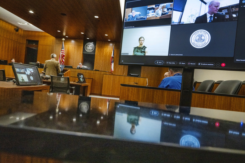Defense attorney Greg Skordas, left, speaks before judge Tony Graf, back center left, as Tyler Robinson, accused of fatally shooting Charlie Kirk, attends a virtual court hearing from prison on Tuesday, Sept. 16, 2025, in Provo, Utah. 