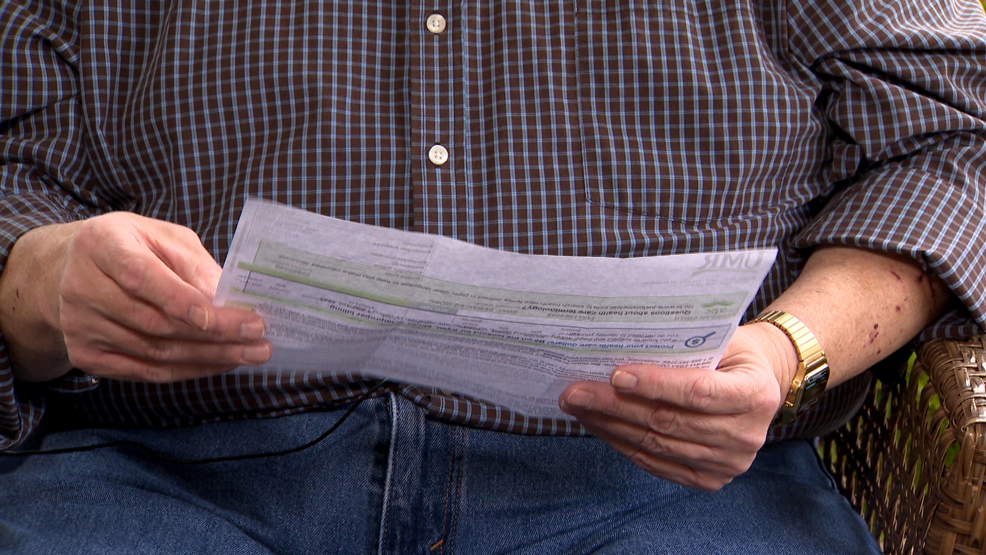 Kenneth Smith reading United HealthCare EOB with fake charges for medical supplies 