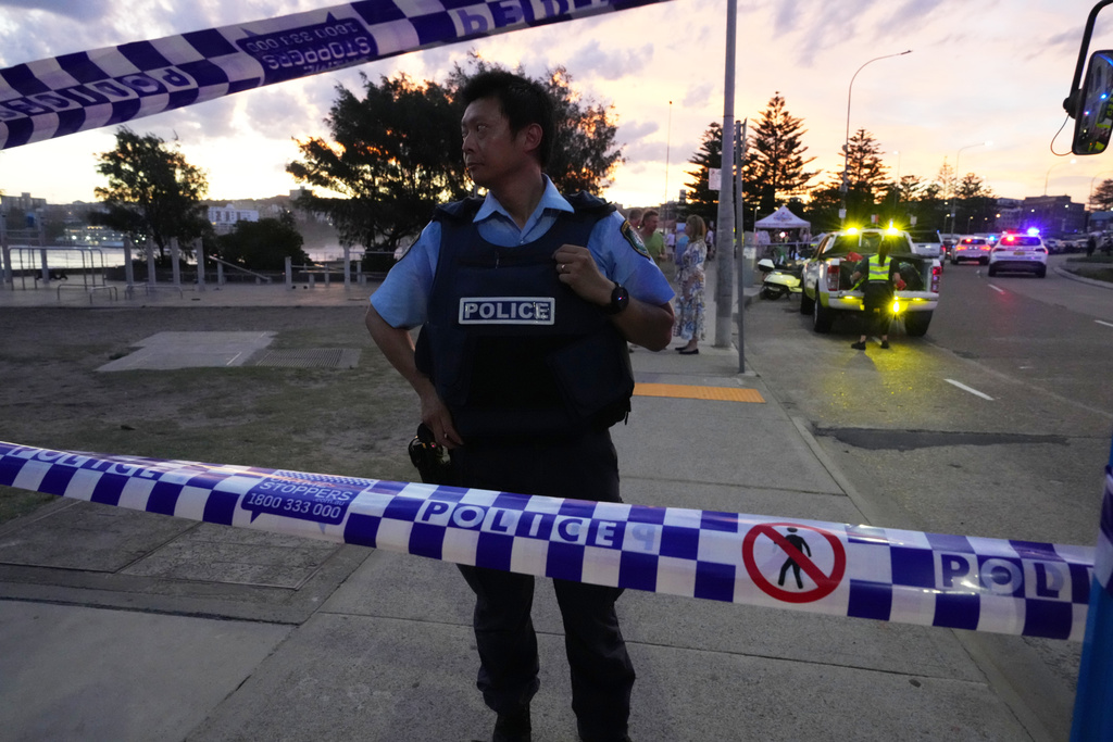 Police cordon off an area at Bondi Beach after a reported shooting in Sydney, Sunday, Dec. 14, 2025. 