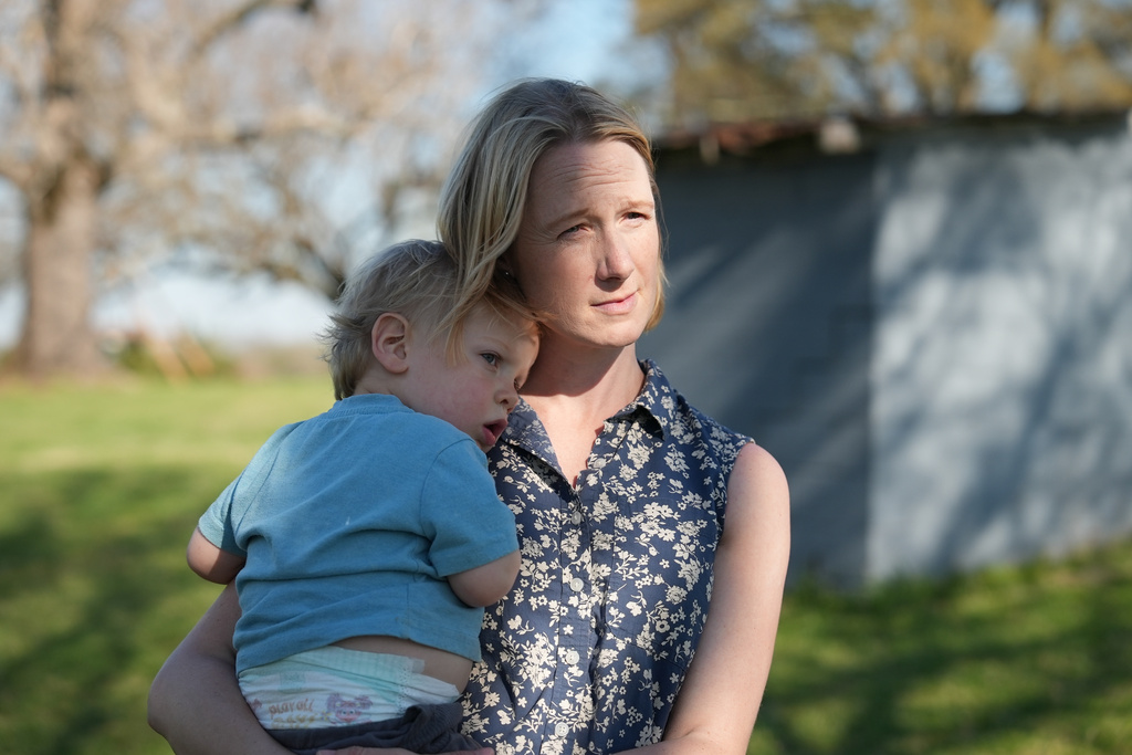 Helen Kaiser holds her son at their home in Landrum, S.C., on March 19, 2026. 