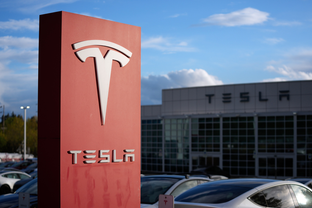 A sign for Tesla is displayed at a facility on Wednesday, April 15, 2026, in Portland, Ore. 