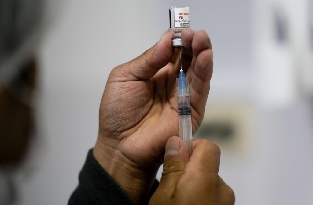 A healthcare worker prepares a shot of the Pfizer COVID-19 vaccine.