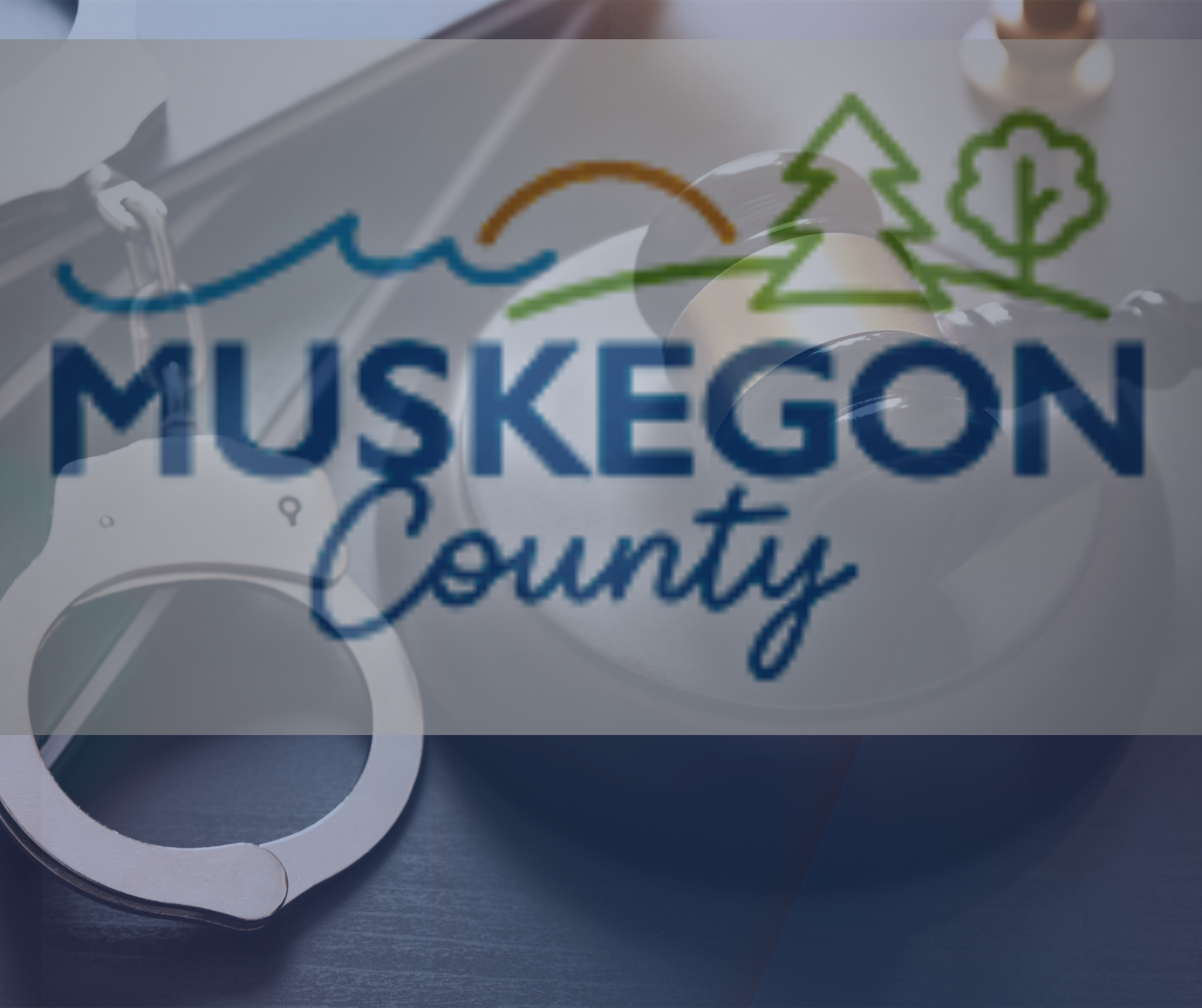 Handcuffs and gavel - Muskegon  County Emblem - FOX 17 Blue Backer.png