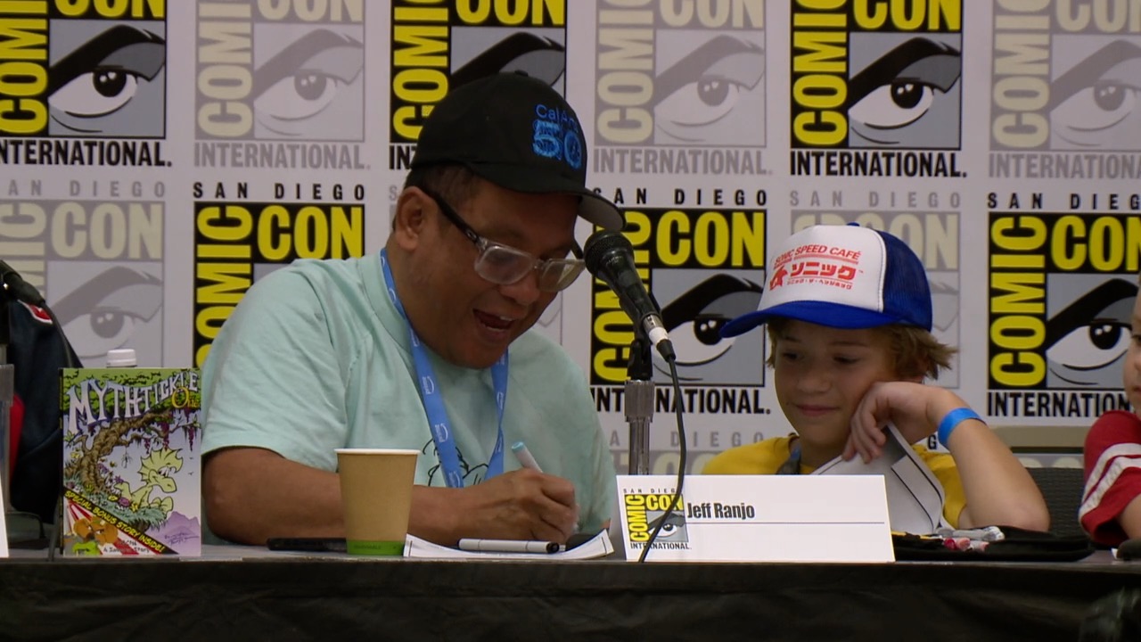 Harrison Graph (right) gets hand-drawn picture from Jeff Ranjo (left), an animator for Netflix.