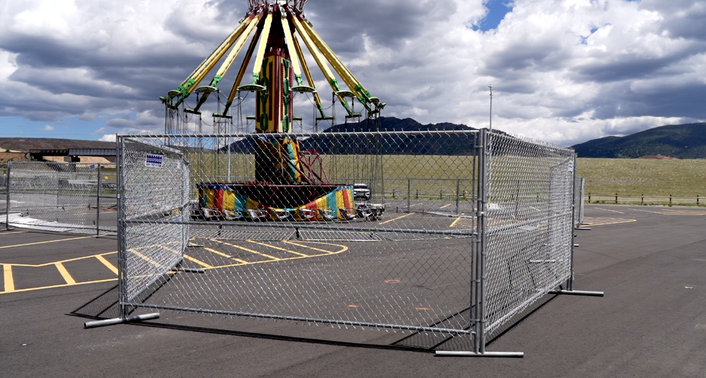 Yoyo carnival ride secured behind metal fencing 