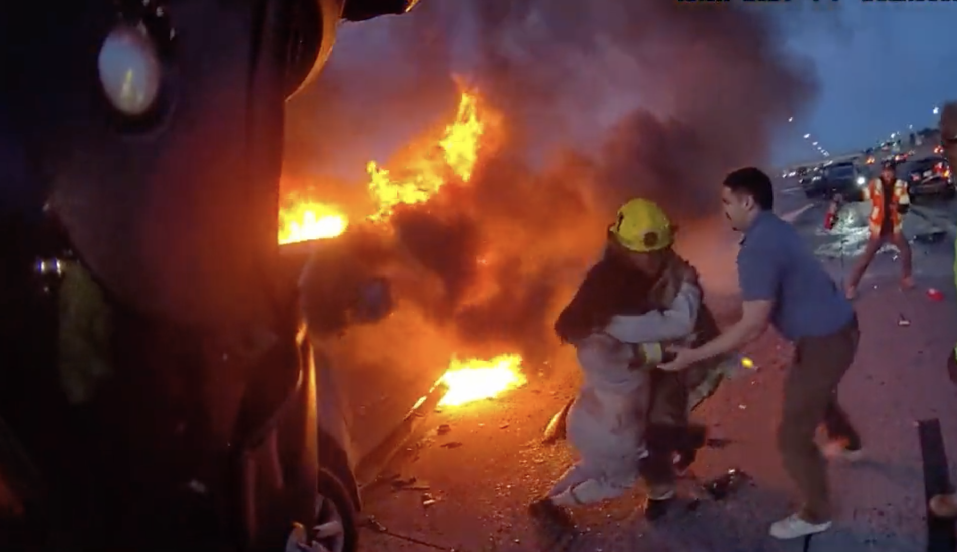Woman pulled from burning vehicle