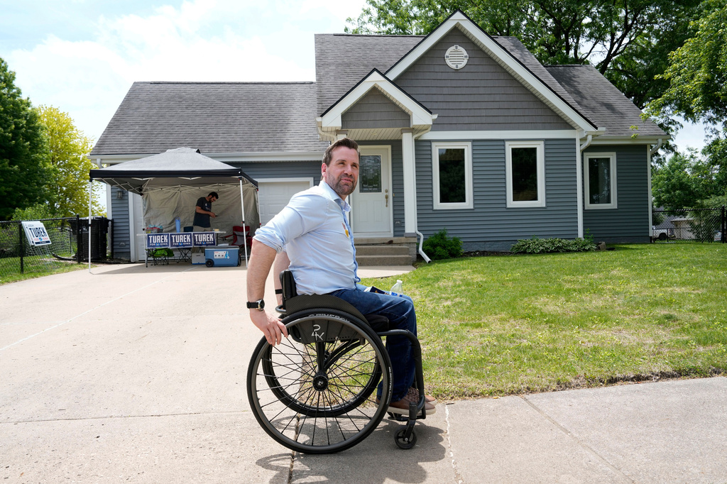 Iowa state Rep. Josh Turek, a Democratic candidate for U.S. Senate, makes his to canvass neighborhood homes, Sunday, May 31, 2026, in Waukee, Iowa. 