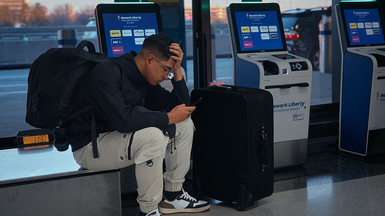 A passenger flying with Arajet to Santo Domingo waits to check in at Newark Liberty International Airport on Friday, Nov. 7, 2025 in Newark, N.J. (AP Photo/Andres Kudacki)