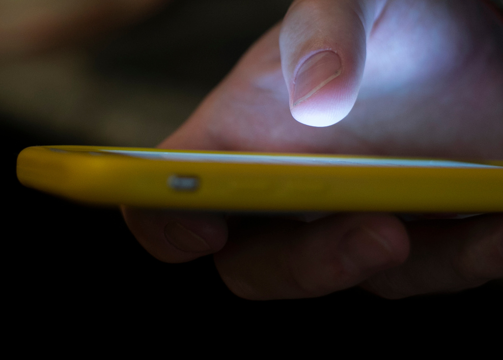 A man uses a cell phone in New Orleans, Aug. 11, 2019. 