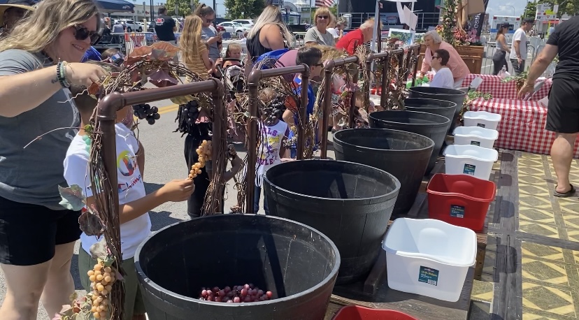 Parents helping their children before Italian Heritage Festival game.