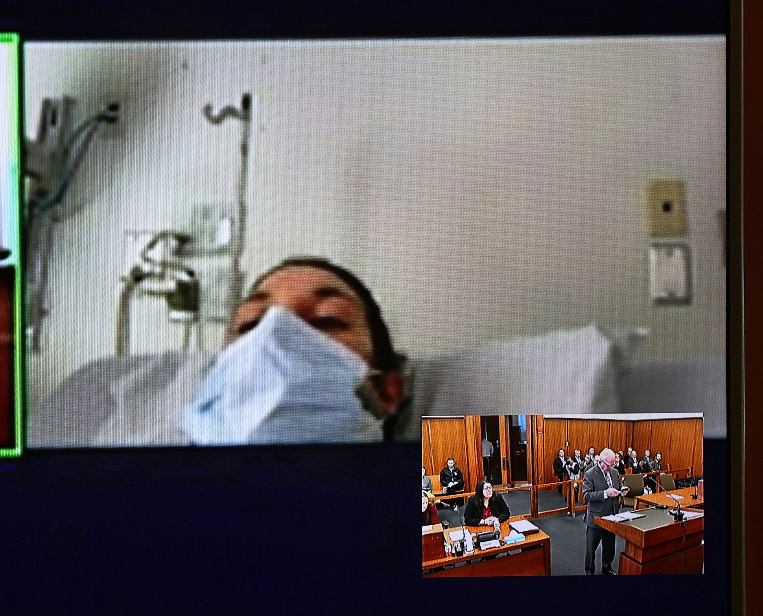 FILE - In this image from video, Lindsay Clancy, with a surgical mask over her face, appears from the hospital for her arraignment on charges regarding the death of her three children, at Plymouth District Court in Plymouth, Mass., on Feb. 7, 2023. 