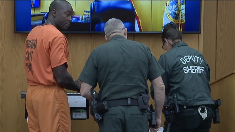 Deputies process Henry Betsey, Jr. after his conviction on a felony bigamy charge