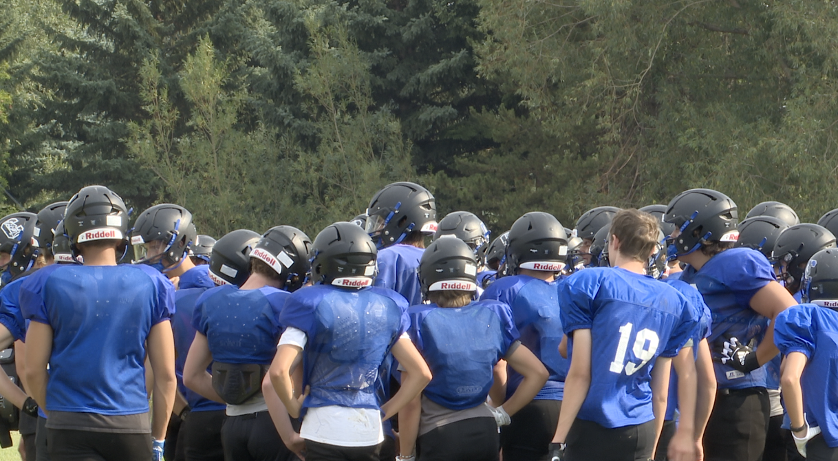 Corvallis football team huddled up at practice