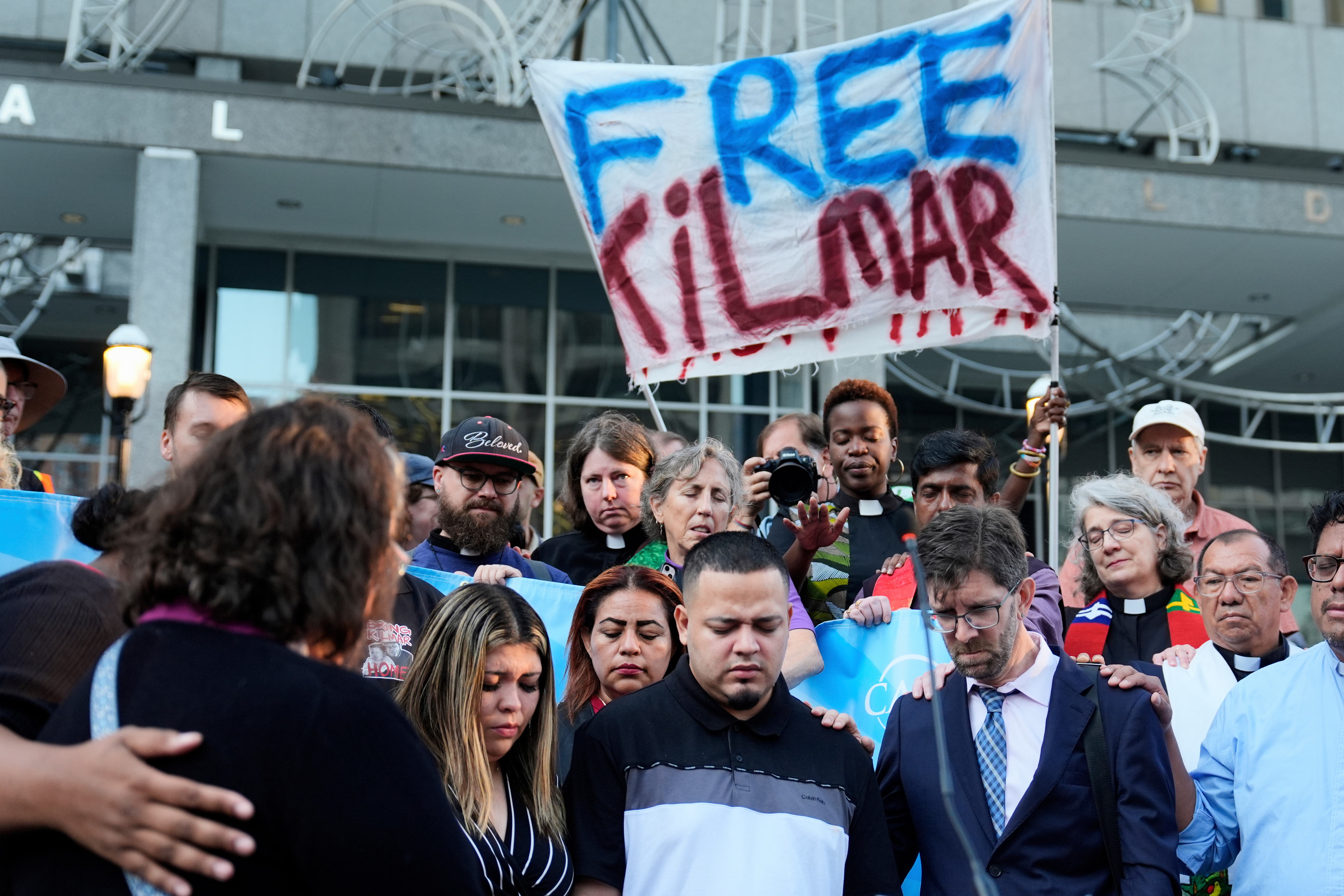 FILE - Jennifer Vasquez Sura, front left, her husband Kilmar Abrego Garcia, front center, and Attorney Simon Sandoval-Moshenberg, front right, attend a protest rally at the Immigration and Customs Enforcement field office in Baltimore, Monday, Aug. 25, 2025, to support Kilmar Abrego Garcia.