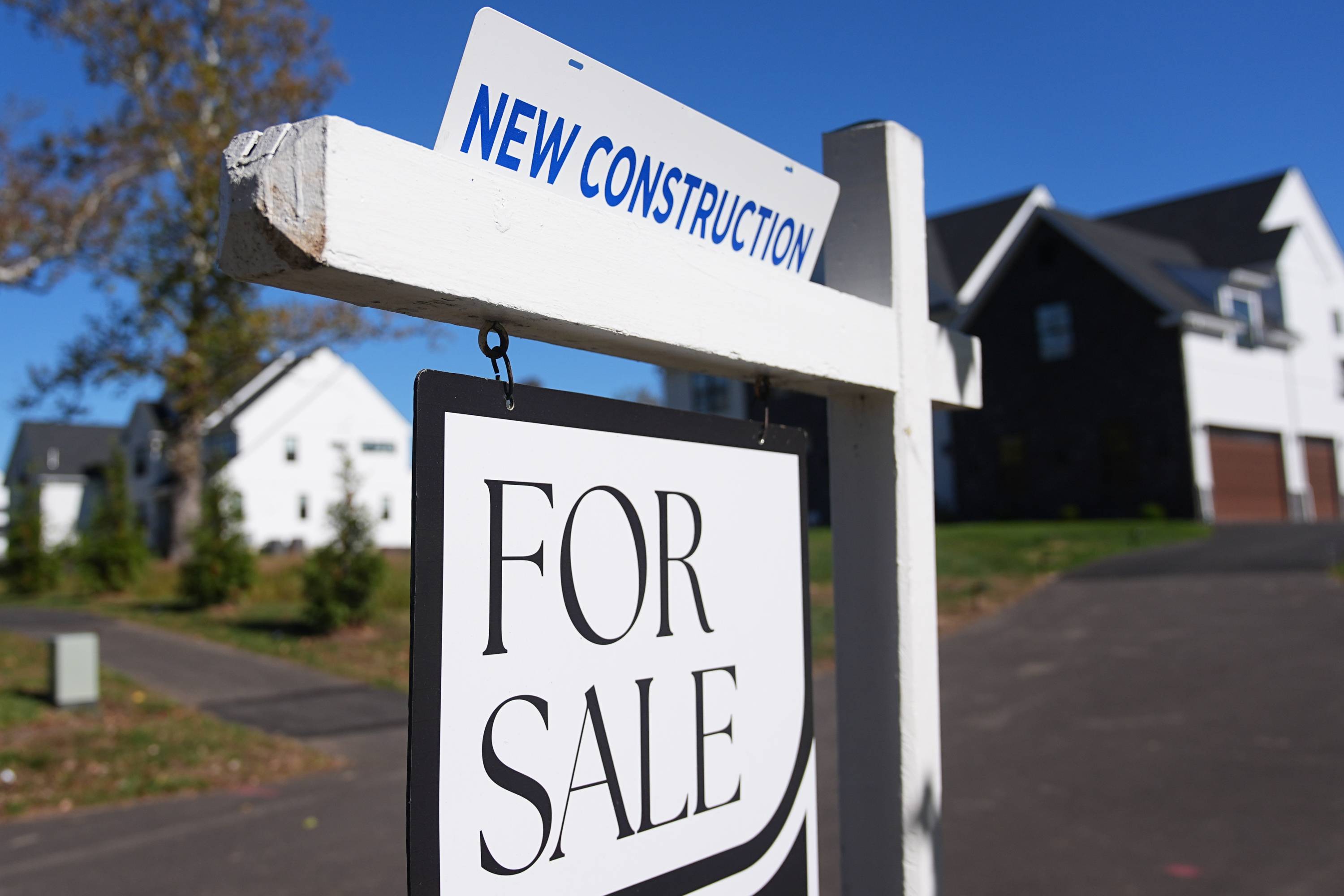 FILE - A sign is posted for a new home for sale.