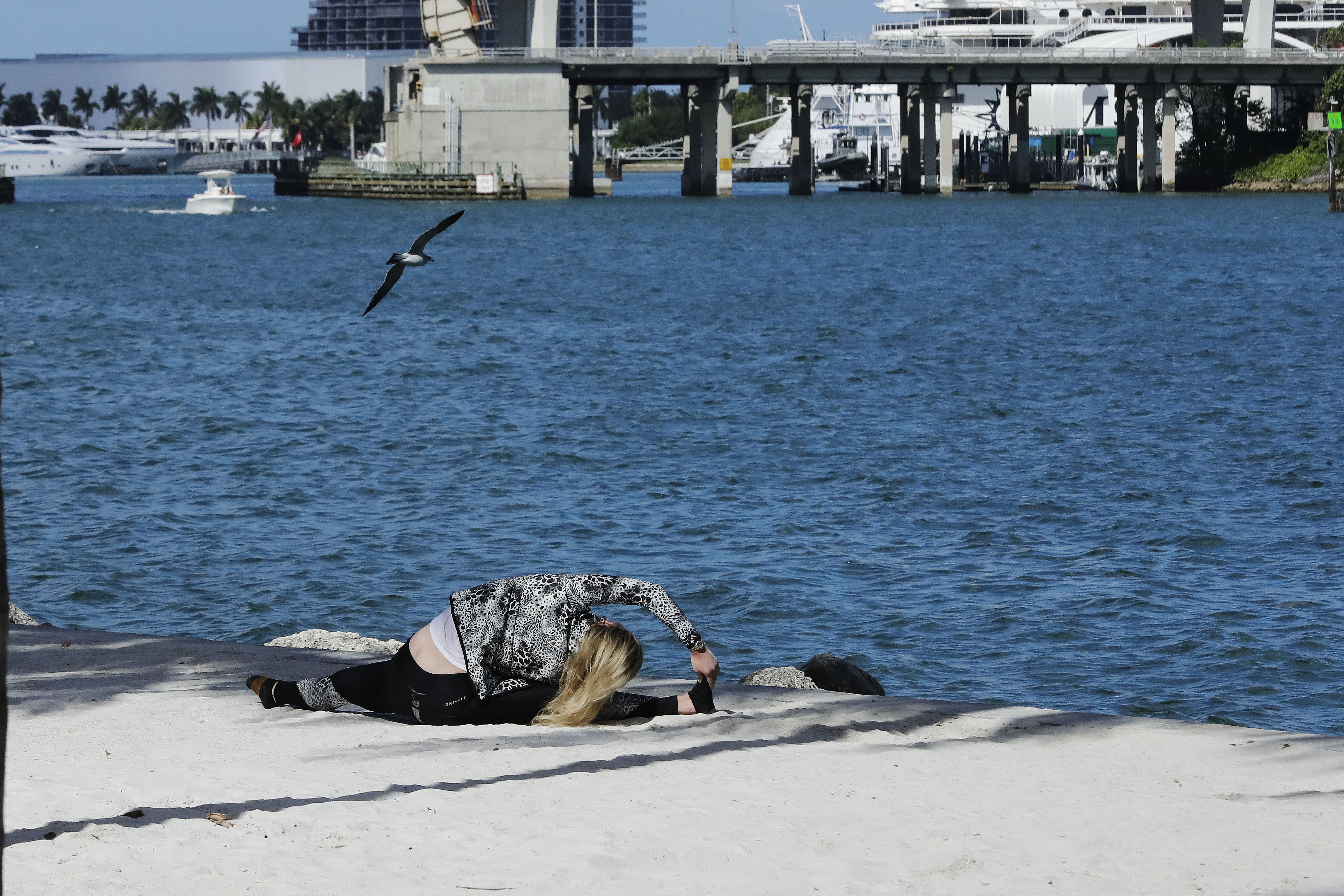 Woman works out near Biscayne Bay in Miami during coronavirus pandemic