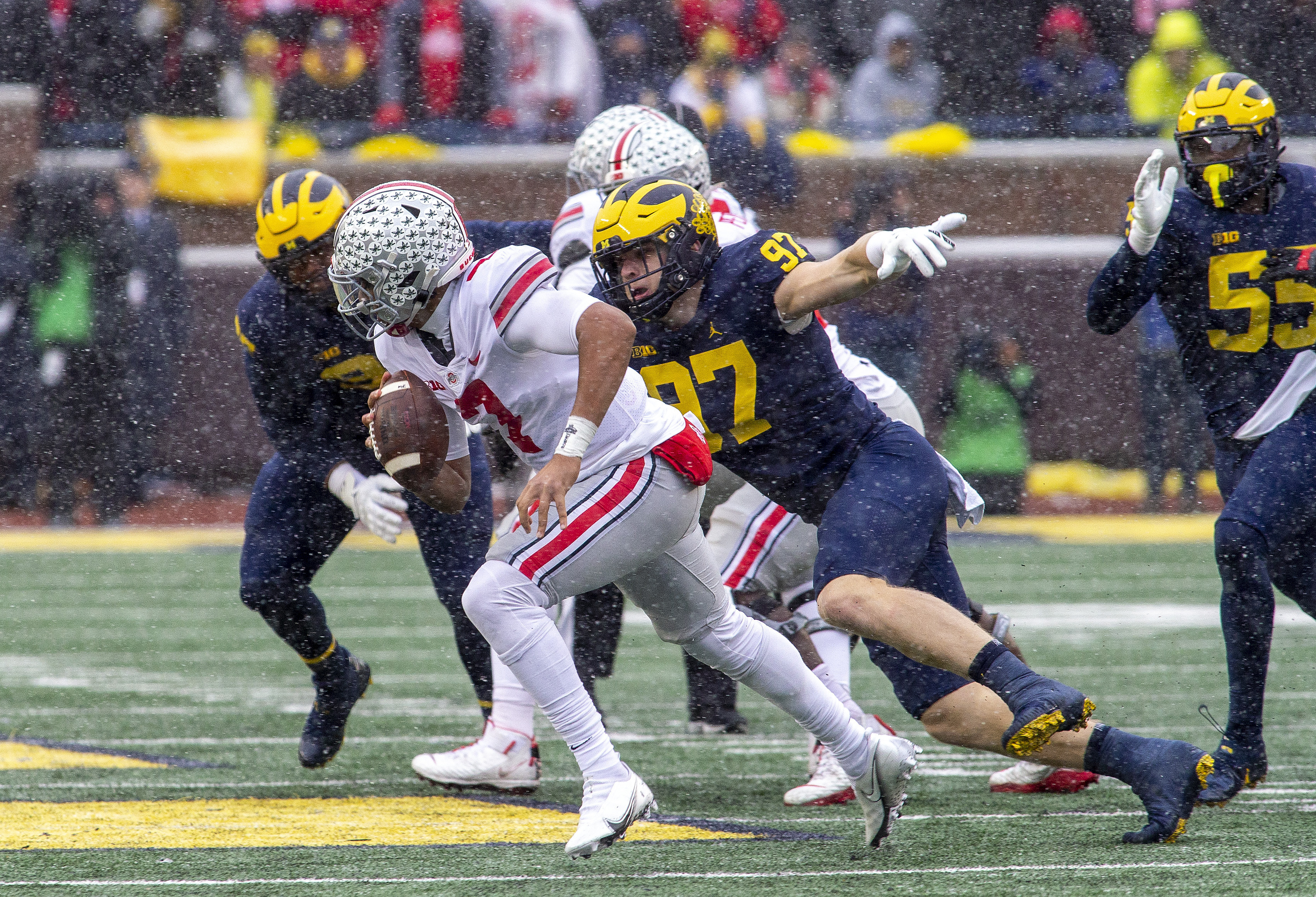 Ohio State Buckeyes QB CJ Stroud runs from Michigan Wolverines defensive end Aidan Hutchinson, Nov. 27, 2021
