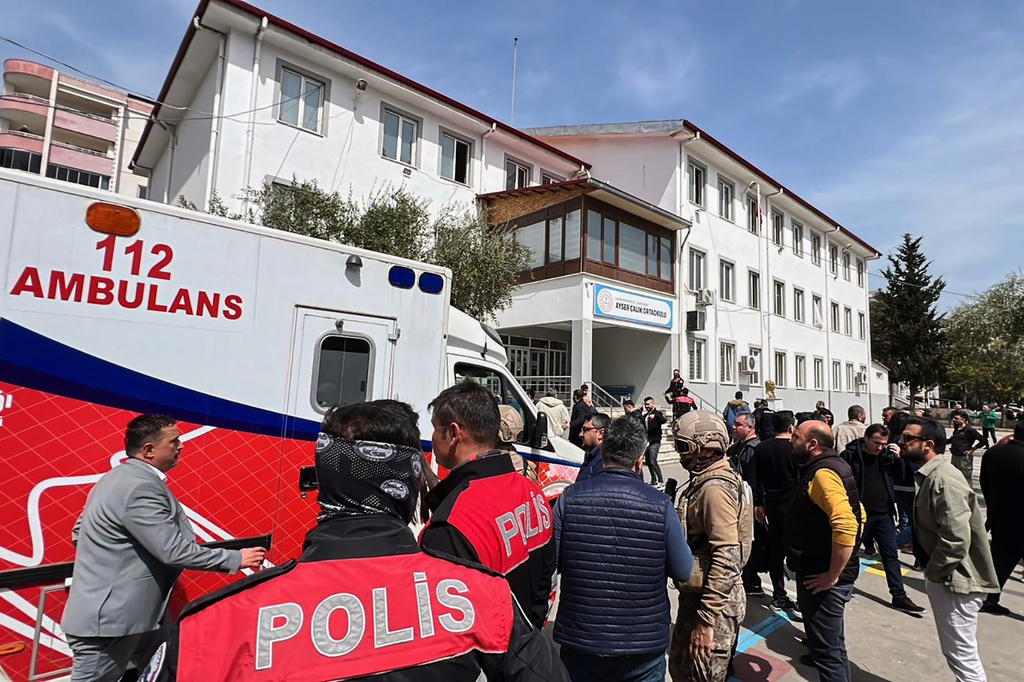 Turkish security forces and emergency staff stand in the courtyard of a secondary school where an assailant opened fire, in Kahramanmaras, Turkey, Wednesday, April 15, 2026.