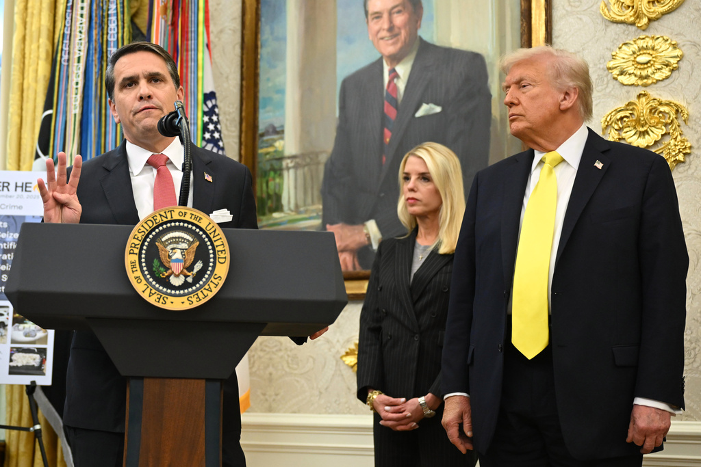 Deputy Attorney General Todd Blanche speaks as President Donald Trump and Attorney General Pam Bondi listen during an event in the Oval Office at the White House, Wednesday, Oct. 15, 2025, in Washington.