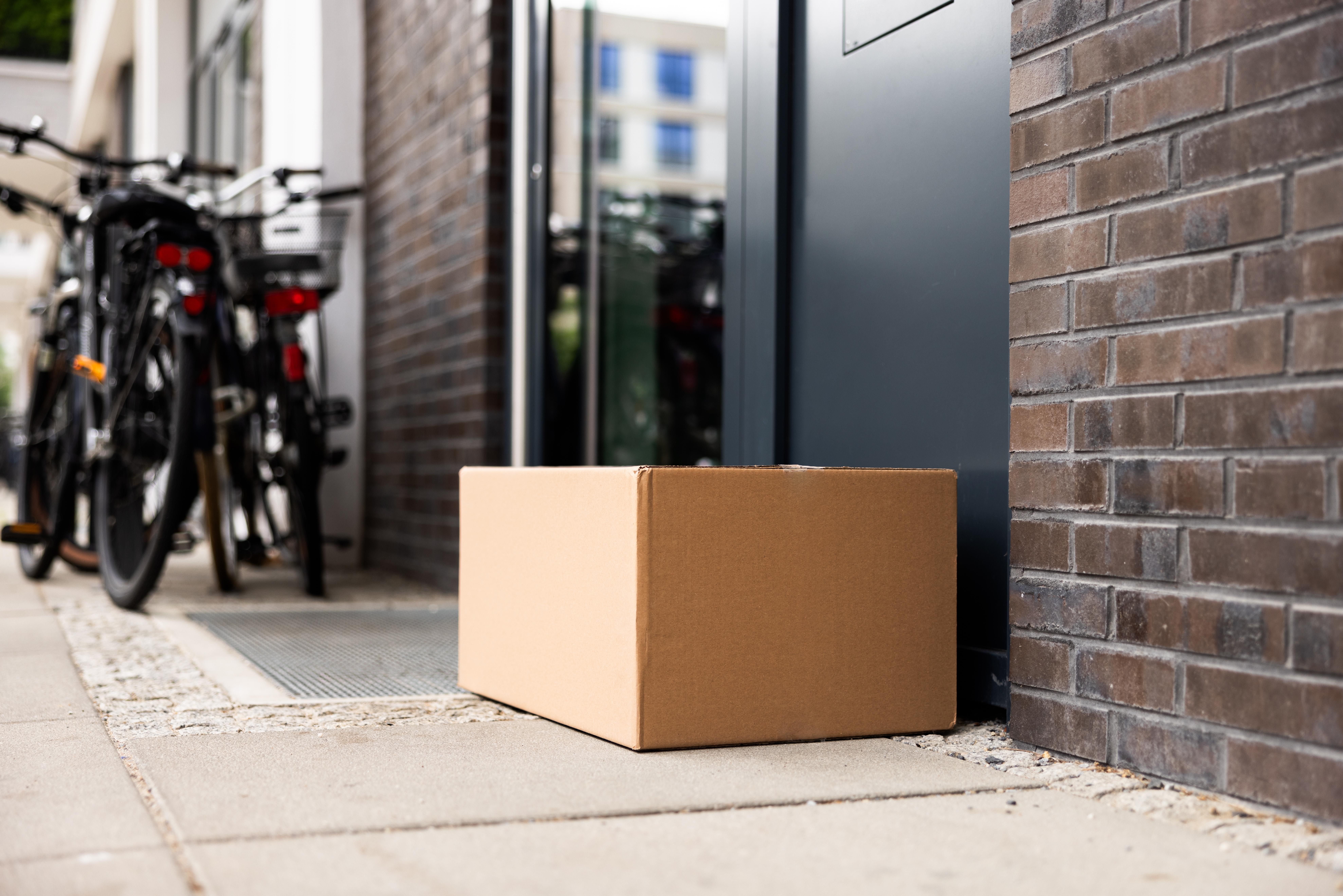 A package at the door of a building. 
