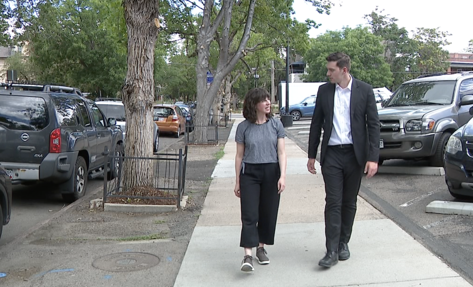 DOTI's Paige Colton walks with Denver7's Ryan Fish on a new sidewalk in Capitol Hill.