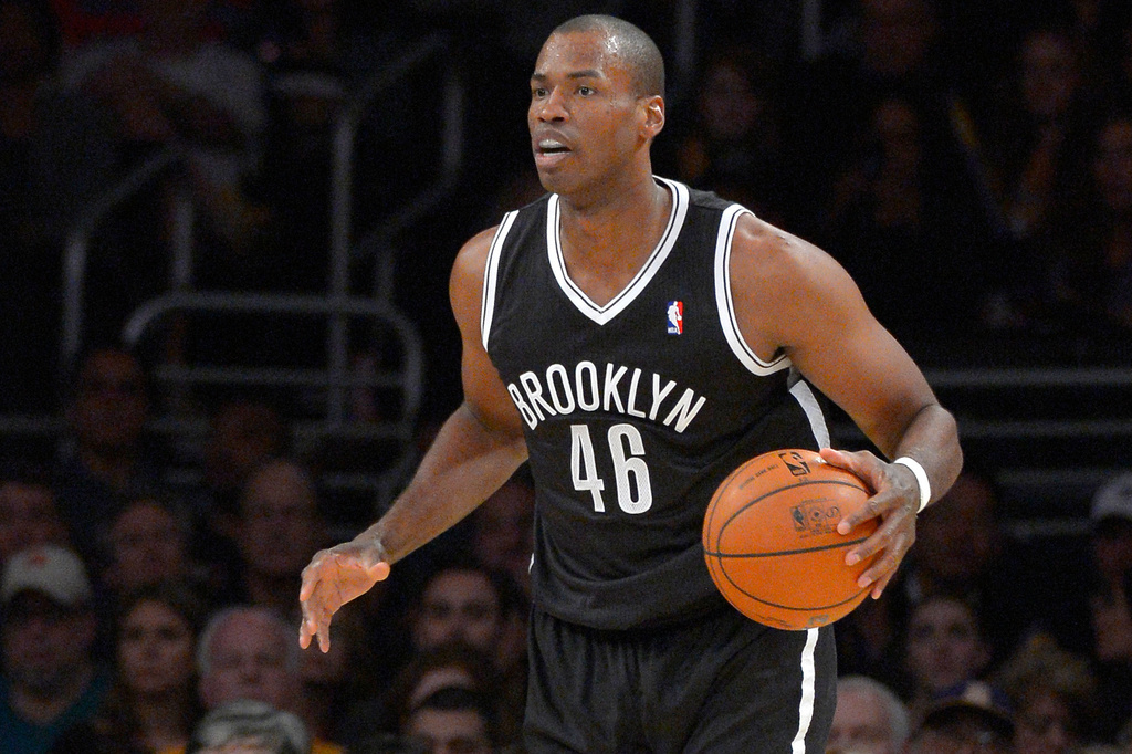 Brooklyn Nets center Jason Collins dribbles the ball during the second half of an NBA basketball game against the Los Angeles Lakers, Feb. 23, 2014, in Los Angeles.