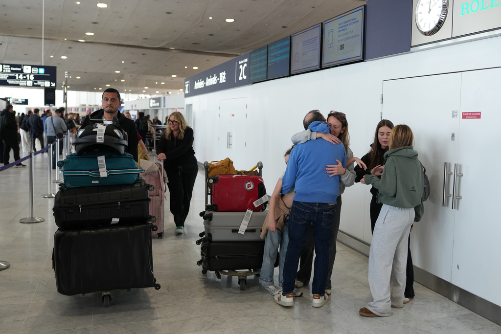 People arrive from Dubai at the Charles de Gaulle international Airport in Roissy, outside Paris, France, Thursday, March 5, 2026. 