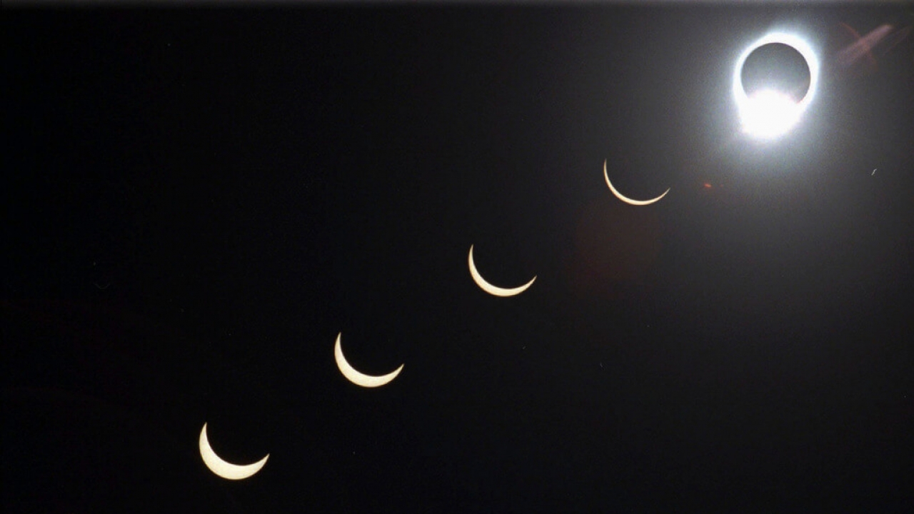 The progression of a total solar eclipse is seen in a multiple exposure photograph.